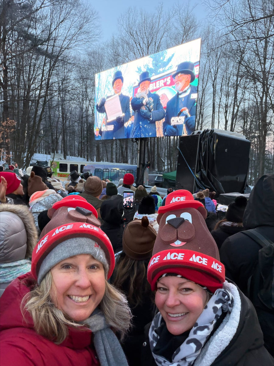 Crowd in custom Ace Hardware foam groundhog hats watching the Groundhog Day ceremony in Punxsutawney