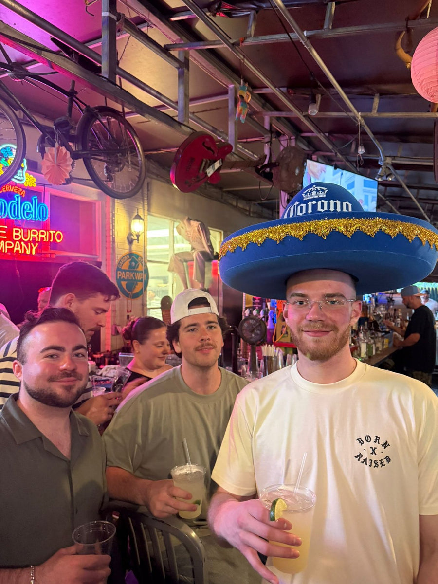 Bar guests wearing giant Corona foam charro hats during a Cinco de Mayo activation